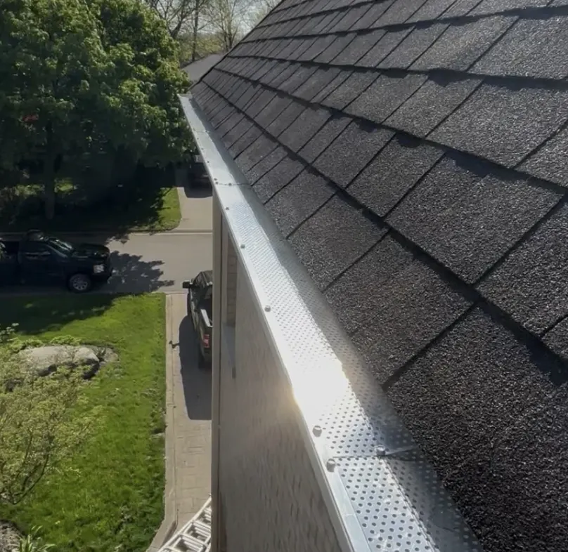 Aluminum mesh gutter guards installed along a residential roofline