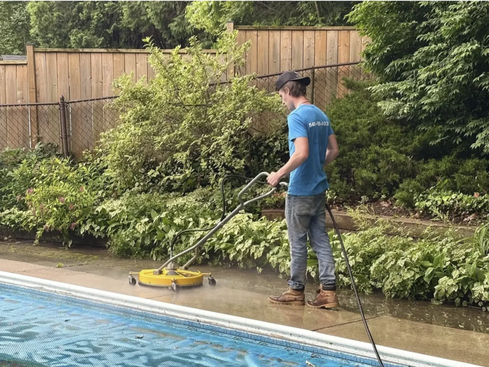 Pressure washing a concrete pool deck in London, Ontario